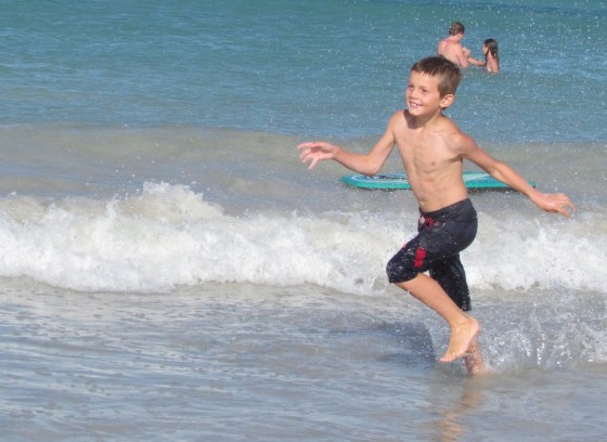 Simon frolicking in the waves