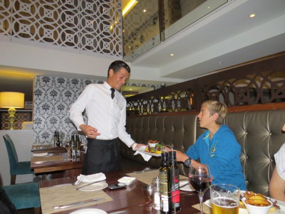 Josh receiving meal from our charming waitron